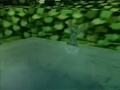 A Clayman climbs out of a tropical river after escaping from the Clayman Factory from the event's trailer.